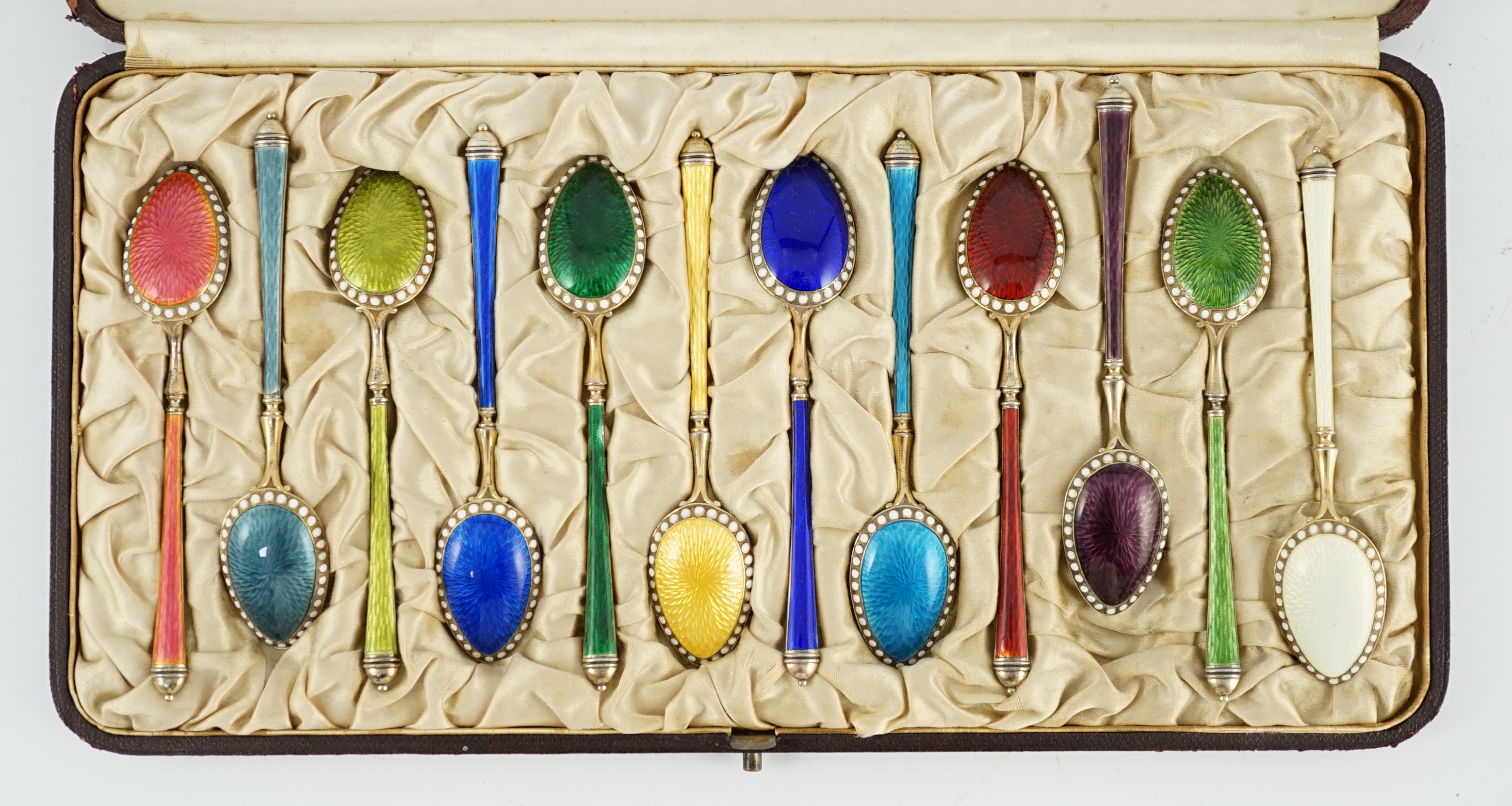 A cased set of twelve Norwegian silver gilt and polychrome enamel coffee spoons, retailed by Tiffany & Co